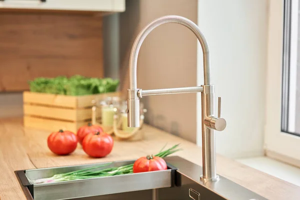 stock image Stylish metallic crane at the kitchen. Sink faucet at the kitchen. Metal crane in close-up photo. Details of the interior of the kitchen in the house. High quality photo