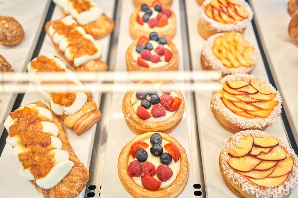 stock image A variety of fresh pastries in the bakery window. almond croissant is fresh and hot in a cafe next to other types of pastries. The interior of an Italian restaurant. High quality photo