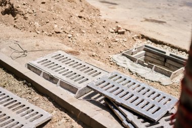 Fırtınalı su sistemi için beton rögar kapakları ve drenaj boruları döşemek. İnşaat alanındaki beton rögar yapısına bir hendek drenajı bağlamak. Fırtına suyu ve yeraltı tesisleri inşa edin. Yüksek