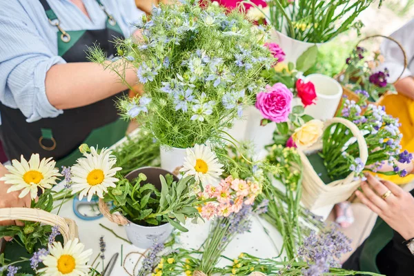 Master class on making bouquets. Spring bouquet in wicker basket. Learning flower arranging, making beautiful bouquets with your own hands. High quality photo