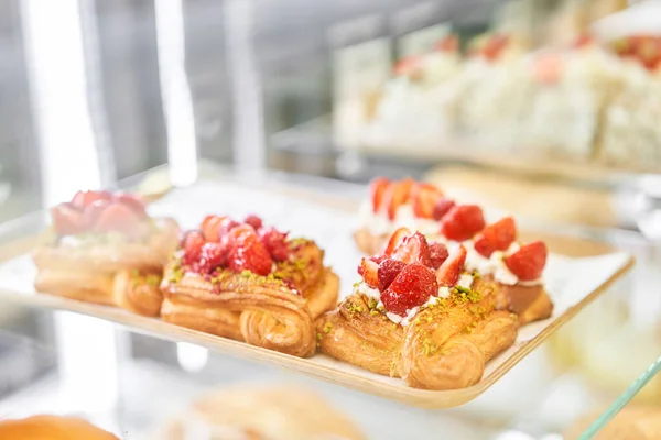 stock image A variety of fresh pastries in the bakery window. almond croissant is fresh and hot in a cafe next to other types of pastries. The interior of an Italian restaurant. High quality photo