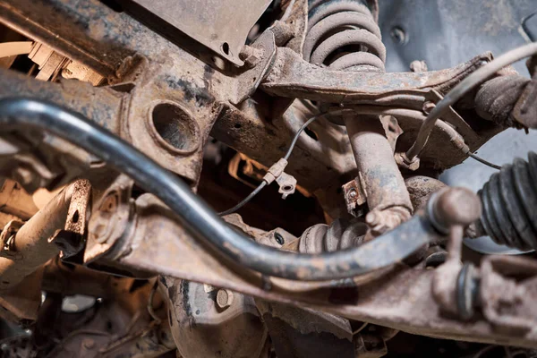 stock image Car mechanic inspecting car wheel and repair suspension detail. Lifted automobile at repair service station. replacement of ferrule and leverage. High quality photo