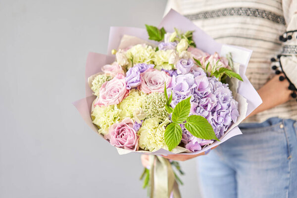 Beautiful bouquet of mixed flowers in woman hand. Floral shop concept . Beautiful fresh cut bouquet. Flowers delivery. High quality photo