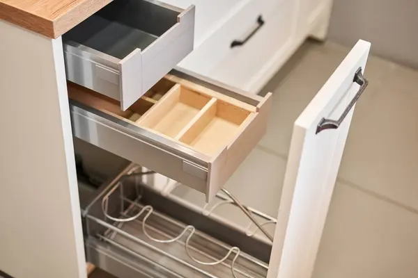 Empty storage box. Open drawer for different utensils and storage. Kitchen utensil cutlery drawer organizer tray with simple set of tools, minimalist order. Order in kitchen. Kitchen furniture store
