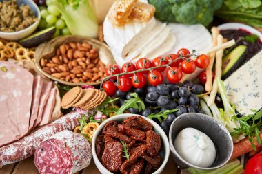 Table full of mediterranean appetizers, tapas or antipasto. Assorted Italian food set. Delicious snack on party or picnic time. Meat and cheese. Italian style banquet. . High quality photo