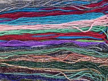 Full frame shot of colorful small beads necklaces