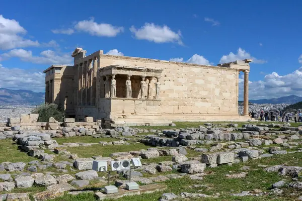 stock image Explore the architectural marvel of the Erechtheion, a captivating landmark atop the Acropolis, drawing tourists and serving as a commercial asset for travel promotions and historic appreciation