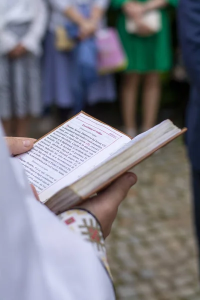 priest holding the prayer book at the baptism. High quality photo