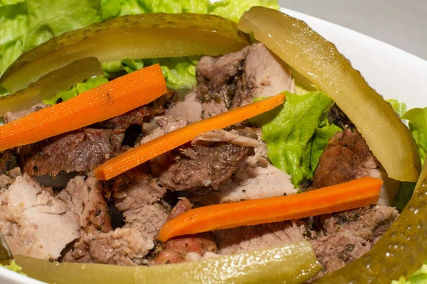 pork steak with pickled carrots and cucumbers. High quality photo