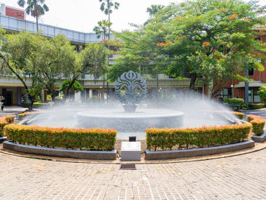 Depok, West Java, Indonesia - August 12, 2022: Large landscape view of the fountain pool garden in front of the faculty administration building, the University of Indonesia.
