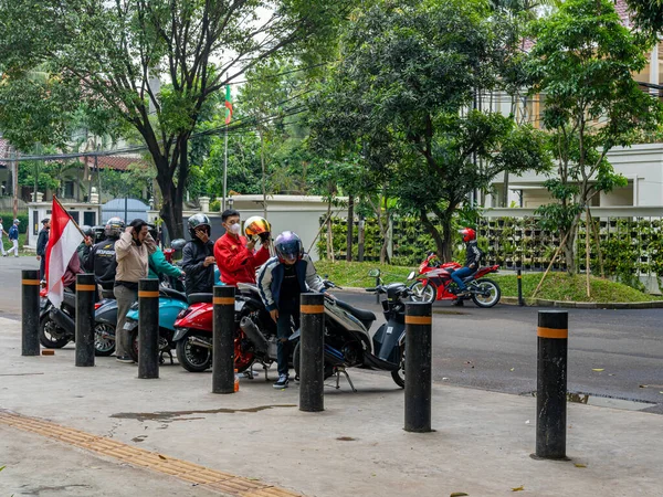 Jakarta, Indonesia - August 16, 2022: A motorcycle club ready for a touring with a flag during a commemoration of the Indonesian independence at a public park.