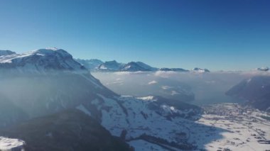 Great aerial footage in 4K on a gloriously sunny day over the snowy landscape of the canton of Lucerne in Switzerland.