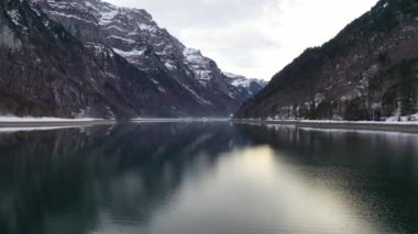 Great aerial footage in 4K over a mountain lake in Switzerland in the canton of Glarus called Klntalersee.