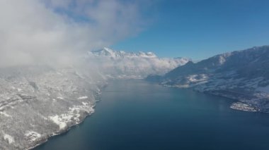 Great aerial footage in 4K over a dreamy snowy landscape in the Swiss mountains.