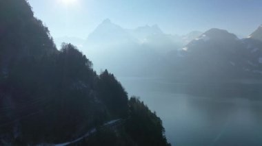 Great aerial footage in 4K over lakes and villages in snow-covered Switzerland in winter.