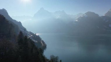 Great aerial footage in 4K over the wintry landscape in the Swiss Alps.