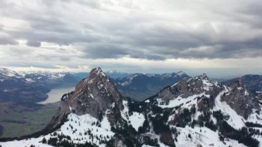 Great 4K aerial footage over a snowy forest in the middle of Switzerland in the canton of Schwyz in Einsiedeln.