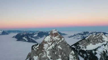 Great 4K aerial footage of a wintry dream landscape in Switzerland during a colorful winter sunrise.