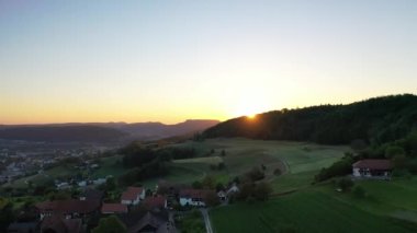 Great 4K aerial footage of agricultural fields in Switzerland harvesting lots of corn.