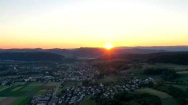 Great 4K aerial footage of agricultural fields in Switzerland harvesting lots of corn.