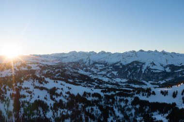 Epic drone photo of a sunrise in the Swiss mountains around a big mountain called Grosser Mythen.