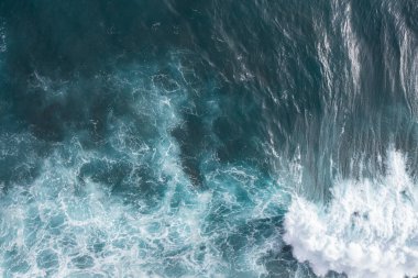 Perfect waves for surfing. The waves splash into the turquoise water off the coast.