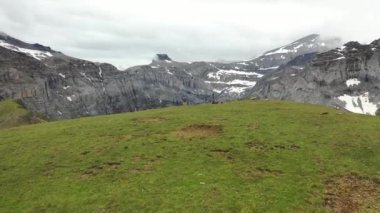 Great 4K aerial footage over a mountain ridge in the canton of Glarus and a mountain lake called Limmerensee.