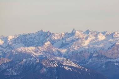 Shot from behind the peaks of the Swiss mountains during the golden hour, perfect for photography.