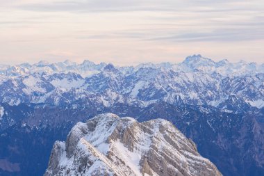 Beautiful colored horizon with red, orange and pink tones behind the mountains of Switzerland.