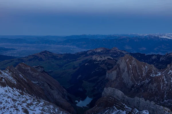 Shot from behind the peaks of the Swiss mountains during the golden hour, perfect for photography.