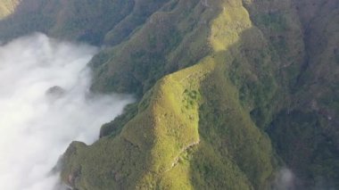 Wonderful flight over the Pica da Cana viewing platform in Madeira, Portugal. Various wind turbines can be seen in the background on the horizon.