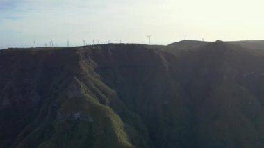 Wonderful flight over the Pica da Cana viewing platform in Madeira, Portugal. Various wind turbines can be seen in the background on the horizon.