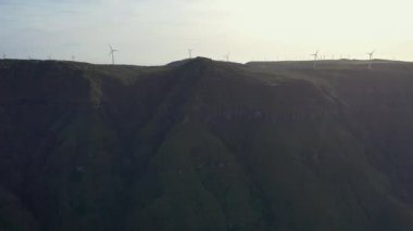 Wonderful flight over the Pica da Cana viewing platform in Madeira, Portugal. Various wind turbines can be seen in the background on the horizon.