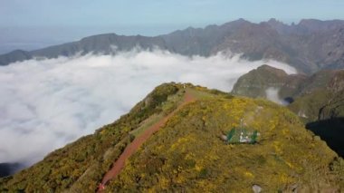 Aerial high above clouds and mountain landscape of Madeira island, Portugal.