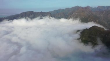 Aerial high above clouds and mountain landscape of Madeira island, Portugal.