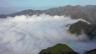 Aerial high above clouds and mountain landscape of Madeira island, Portugal.
