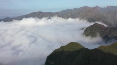 Aerial high above clouds and mountain landscape of Madeira island, Portugal.