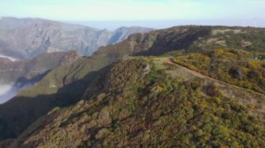 Great sightseeing flight around a hill called Bica da Cana in Madeira, Portugal with a gigantic sea of clouds in the background.
