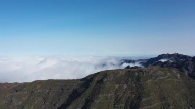 Epic aerial view around one of the highest mountains in Madeira called Pico do Ruivo.