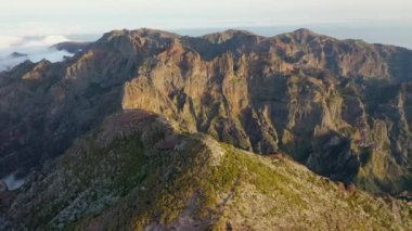 Gigantic drone aerial view over Pico Ruivo with a view of Pico do Arieiro during a beautiful sunset in 4K.