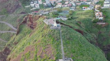 Beautiful aerial footage of Cristo Rei in Madeira on a beautiful Sunday evening during a beautiful sunset in 4K.