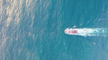 Great aerial footage from above of a boat cruising in the Atlantic Ocean going fishing out to sea.