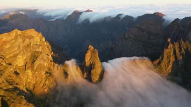 Great aerial footage in 4K of a rock in Madeira called Ninho da Manta with the fog coming through.