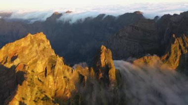 Amazing 4K aerial footage around a rock in Madeira called Ninho da Manta on a beautiful morning with a great sunrise.
