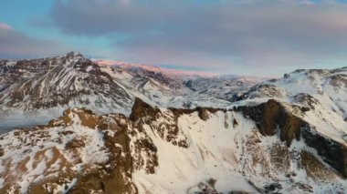 4K Aerial view of snow covered mountains and lava fields in Iceland highlands, Landmannalaugar.