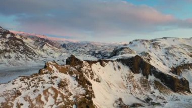 4K Aerial view of snow covered mountains and lava fields in Iceland highlands, Landmannalaugar.