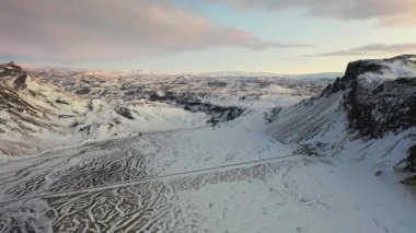 4K aerial footage of snow-capped Iceland in northern Europe at sunset during the midnight sun.