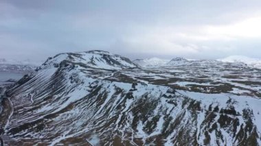 4K aerial footage of a mountain and a beach in a national park in northern Iceland on a foggy day.