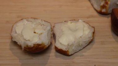 A piece of salami is placed on a lye bread smeared with butter.
