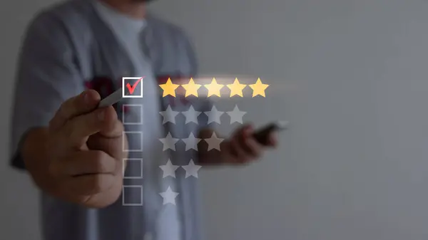 Close up of man customer giving a five star rating on smartphone. Using technology for Review, Service rating, satisfaction, Customer service experience and satisfaction survey concept.